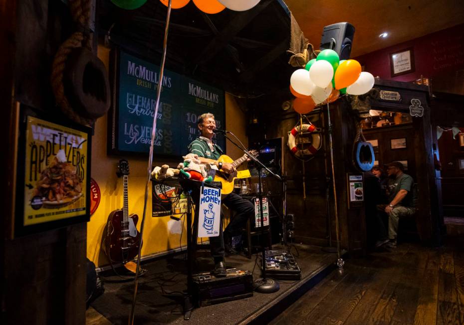 Musician John Windsor performs as people gather to celebrate St. Patrick's Day at McMullan's Ir ...