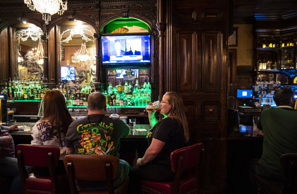 Regina Gordon, Phoenix, drinks by the bar as people gather to celebrate St. Patrick's Day at Ri ...