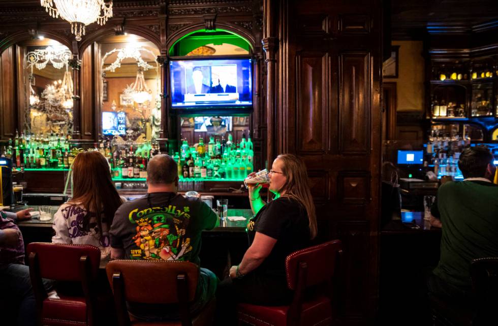 Regina Gordon, Phoenix, drinks by the bar as people gather to celebrate St. Patrick's Day at Ri ...