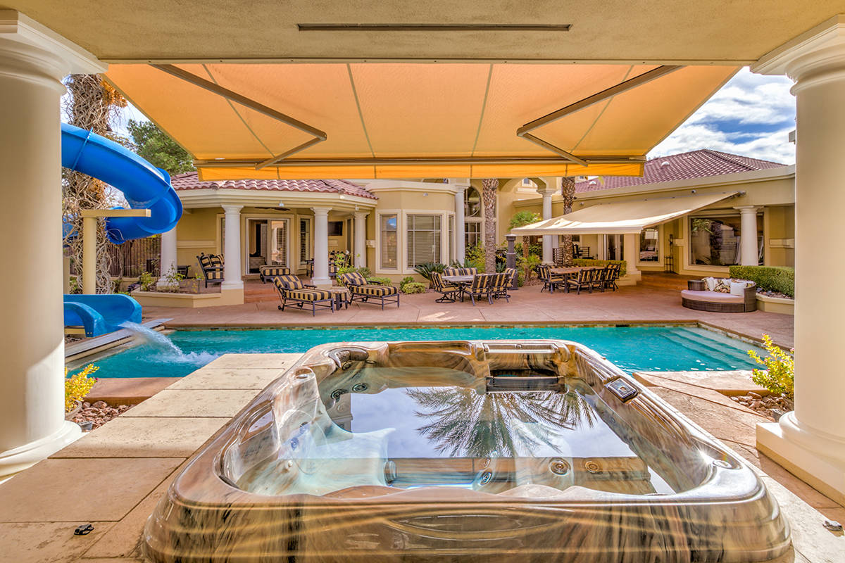 The home was built for entertainment and features a waterslide, fire pits spa and an out door k ...