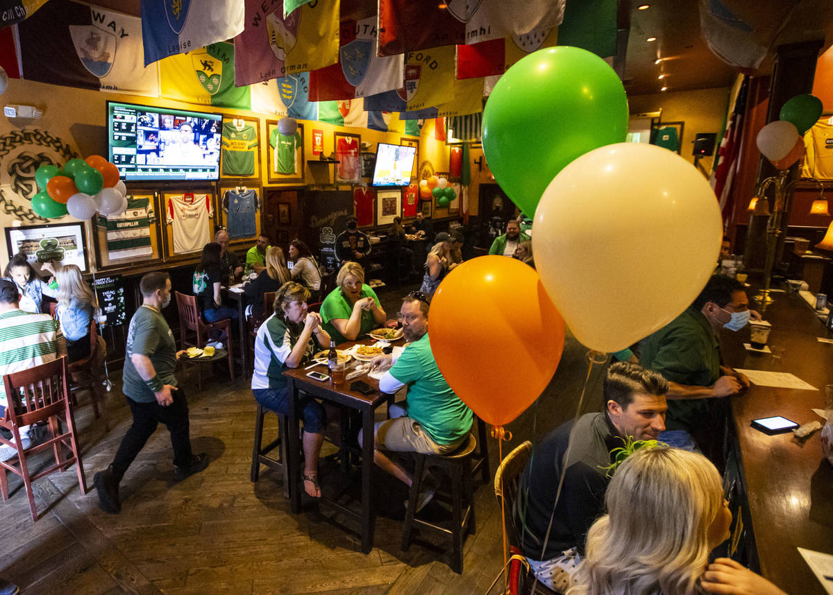 People gather to celebrate St. Patrick's Day at McMullan's Irish Pub in Las Vegas. (Chase Steve ...
