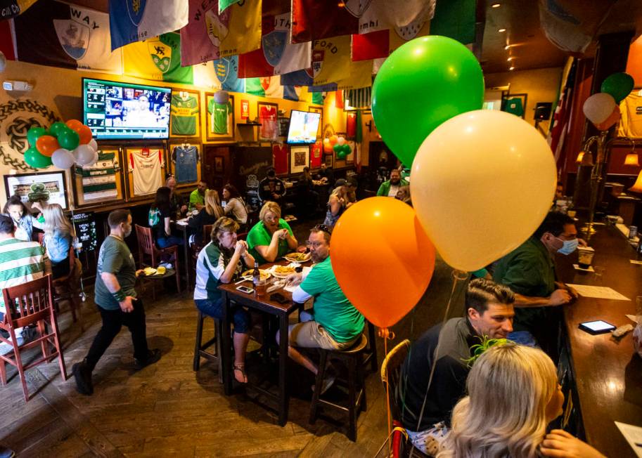 People gather to celebrate St. Patrick's Day at McMullan's Irish Pub in Las Vegas. (Chase Steve ...