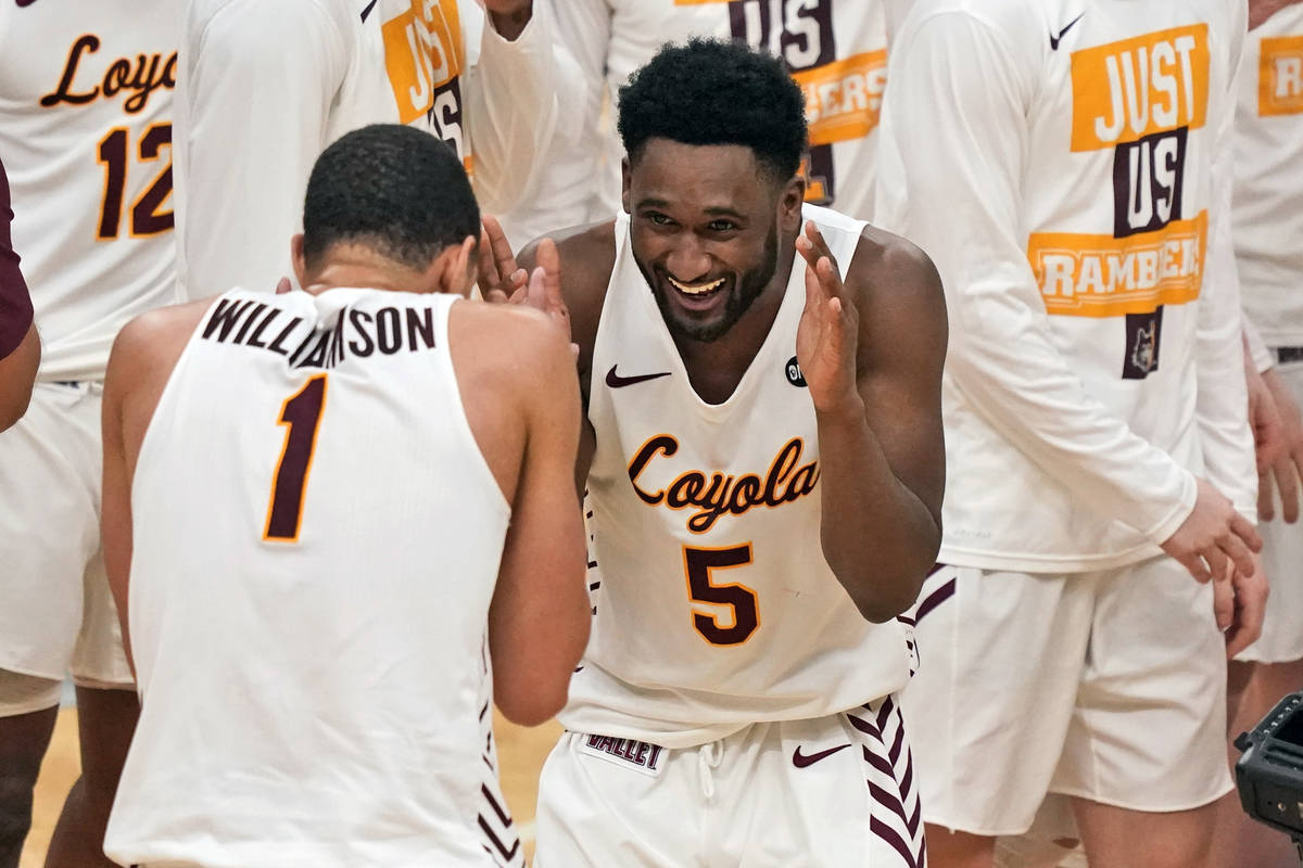 Loyola of Chicago's Keith Clemons (5) and teammate Lucas Williamson (1) celebrate following a 7 ...