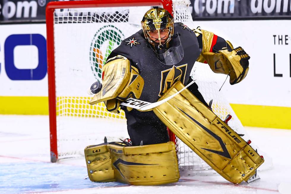 Golden Knights goaltender Marc-Andre Fleury (29) blocks the puck during the first period of an ...