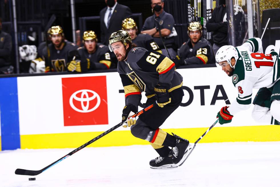 Golden Knights right wing Mark Stone (61) skates with the puck past Minnesota Wild left wing Jo ...