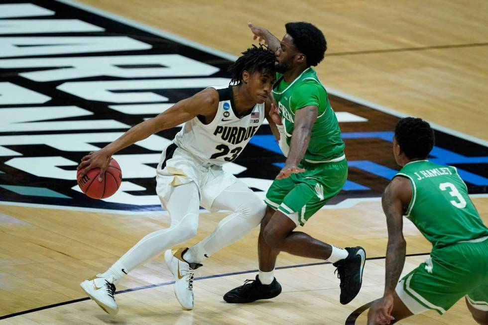 Purdue's Jaden Ivey (23) is defended by North Texas's JJ Murray (11) during the first half of a ...