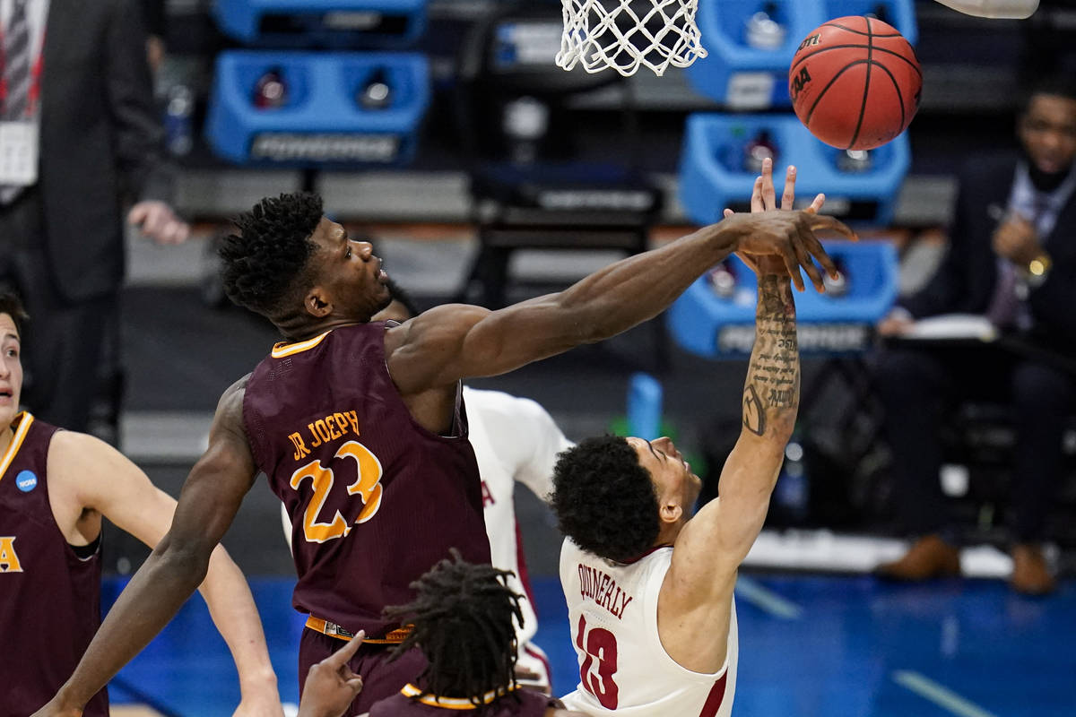 Iona forward Nelly Junior Joseph (23) blocks the shot of Alabama guard Jahvon Quinerly (13) in ...