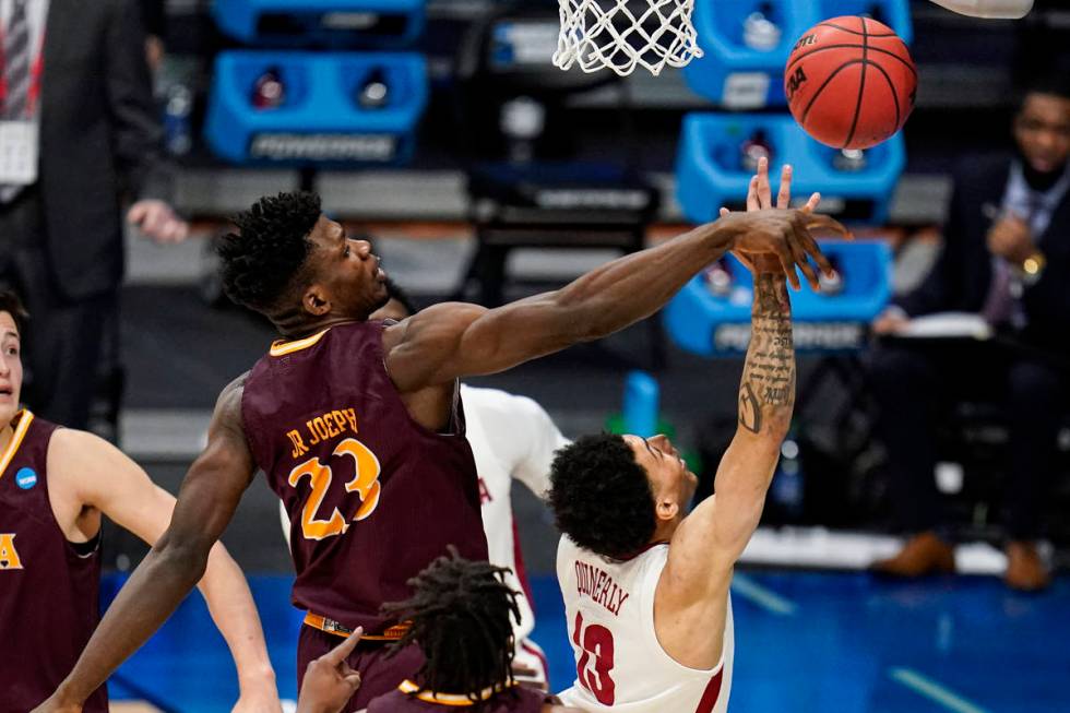 Iona forward Nelly Junior Joseph (23) blocks the shot of Alabama guard Jahvon Quinerly (13) in ...