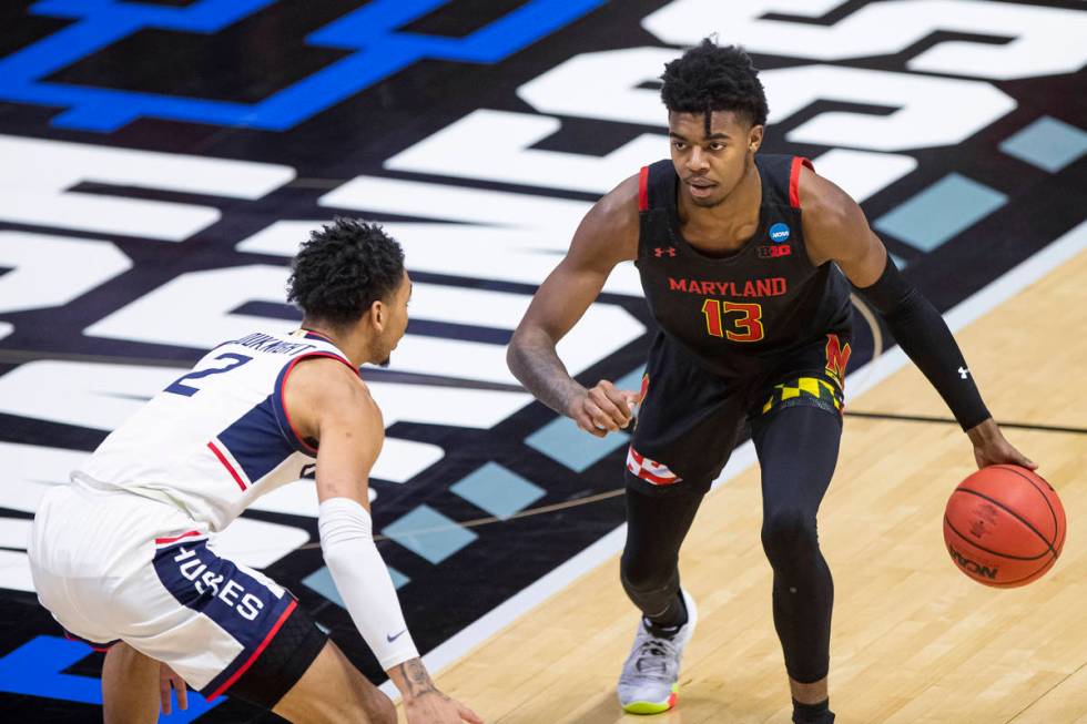 Maryland's Hakim Hart (13) is defended by Connecticut's James Bouknight (2) during the first ha ...