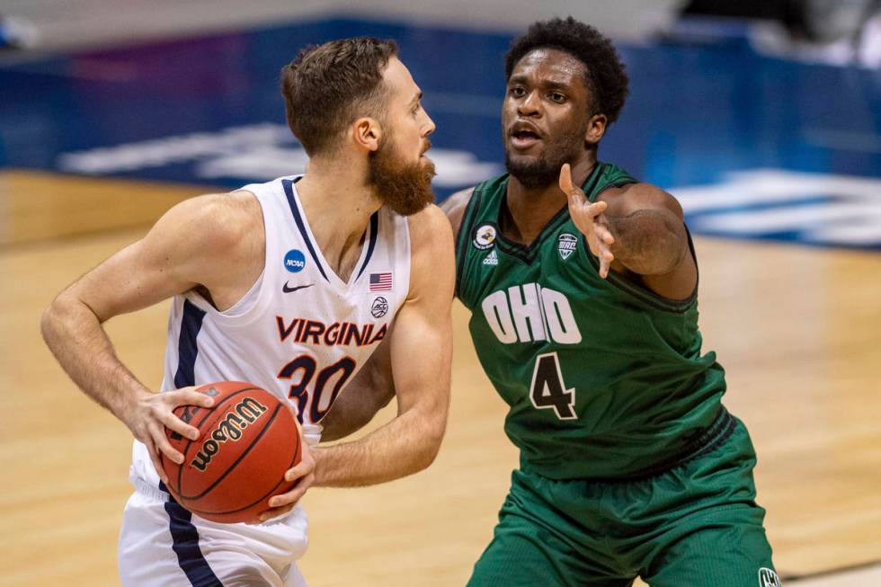 Ohio forward Dwight Wilson III (4) defends against Virginia forward Jay Huff (30) during the fi ...