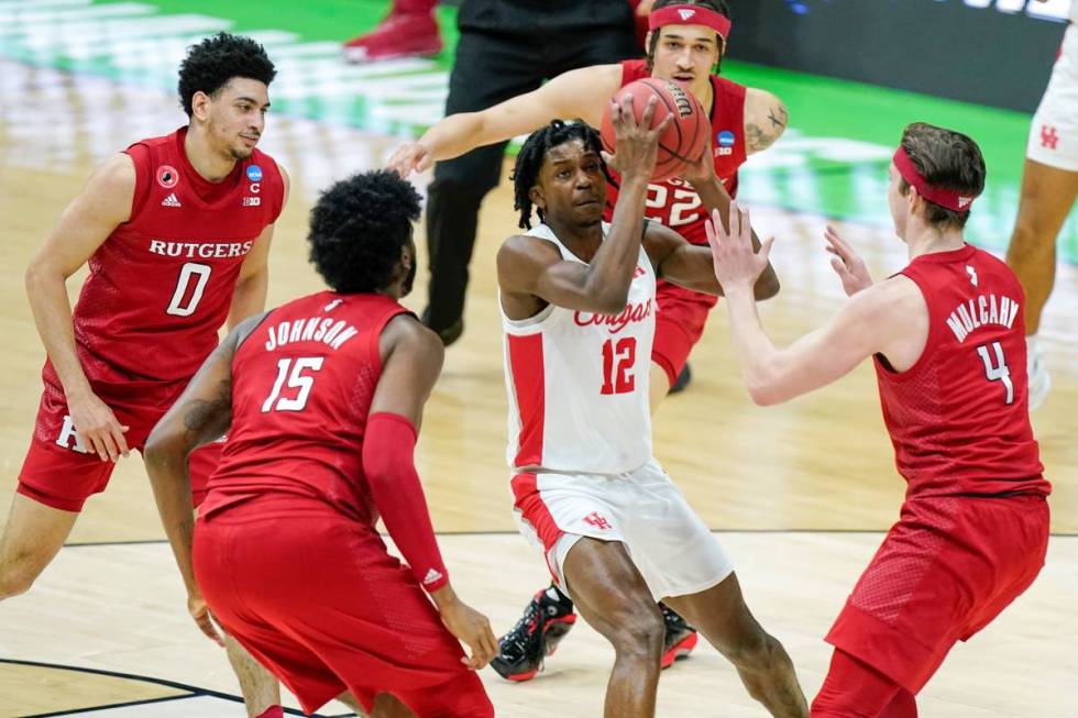 Houston's Tramon Mark (12) ends up in the middle of a group of Rutgers defenders during the fir ...