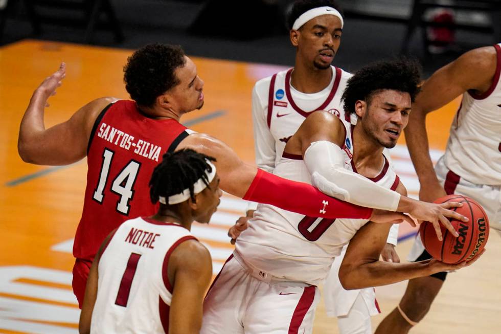 Arkansas forward Justin Smith (0) grabs a rebound from Texas Tech forward Marcus Santos-Silva ( ...