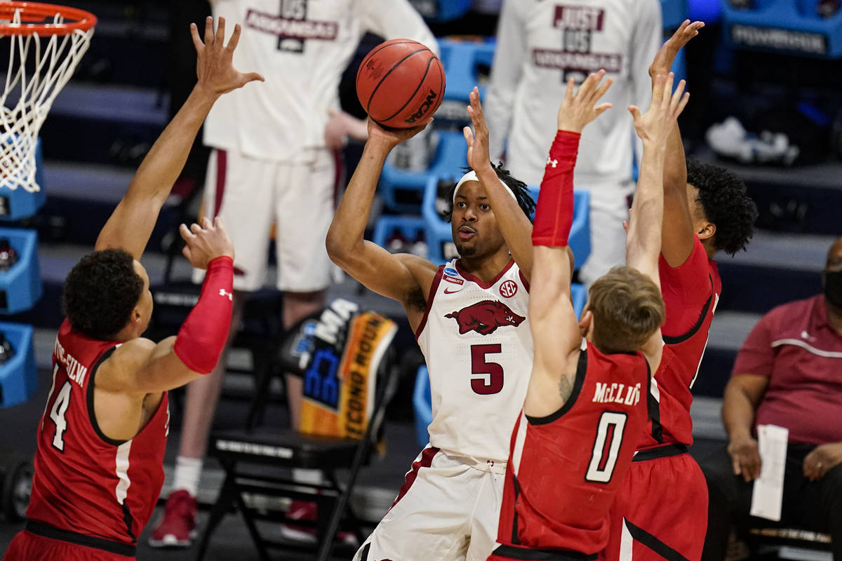 Arkansas guard Moses Moody (5) shoots over Texas Tech forward Marcus Santos-Silva (14) and guar ...