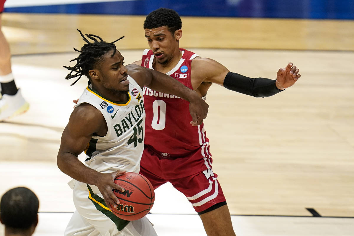 Baylor guard Davion Mitchell (45) drives on Wisconsin guard D'Mitrik Trice (0) in the first hal ...