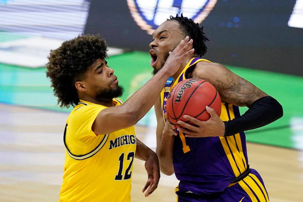 LSU guard Javonte Smart (1) drives to the basket past Michigan guard Mike Smith (12) during the ...