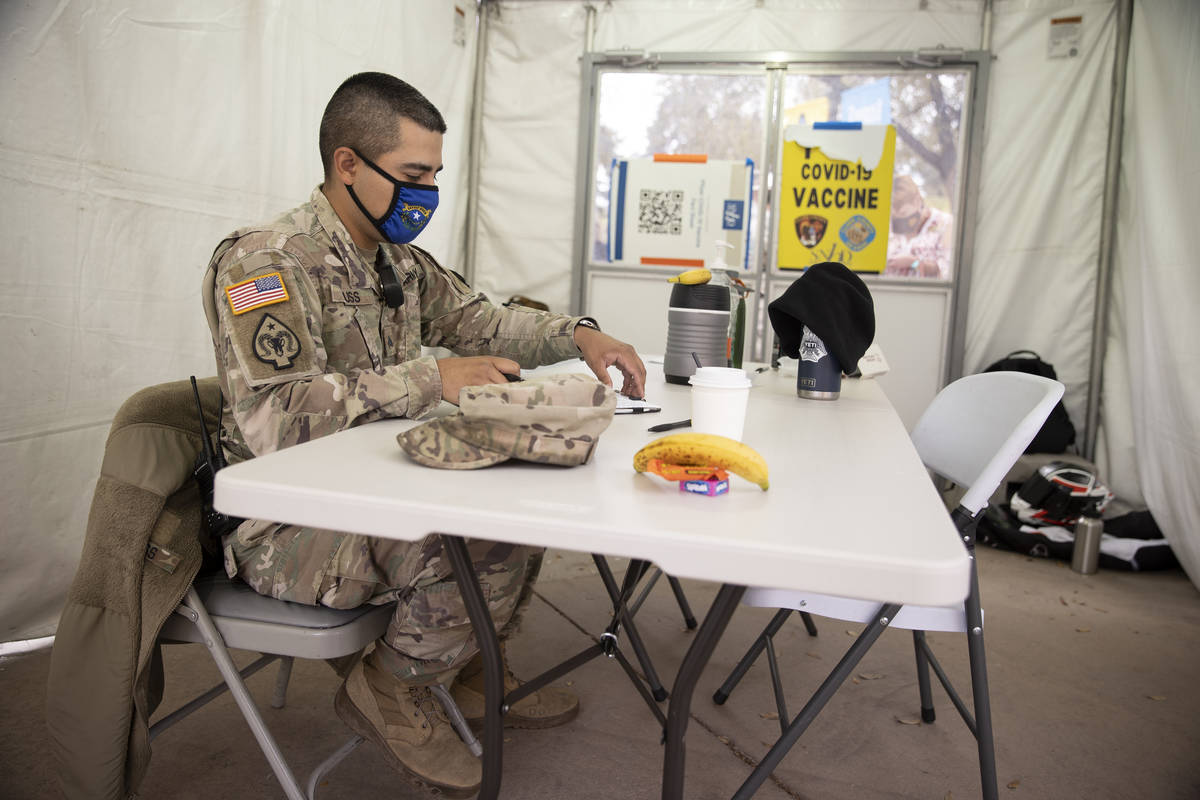 Nevada National Guard Sgt. John Huss works inside an operations tent at the Cashman Center in L ...