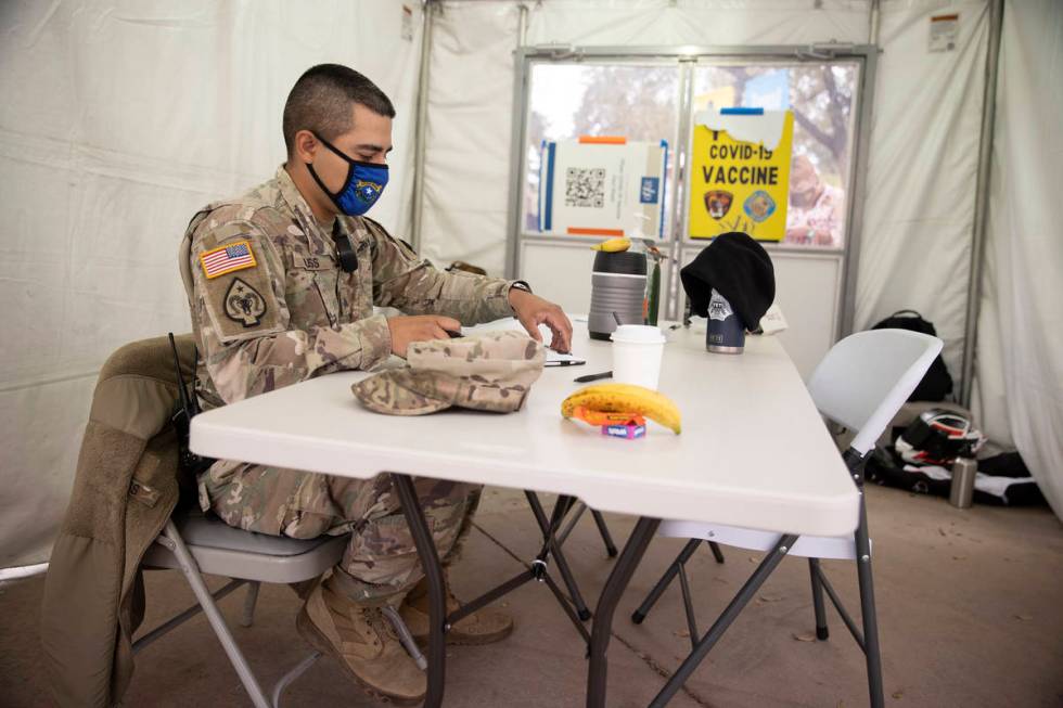 Nevada National Guard Sgt. John Huss works inside an operations tent at the Cashman Center in L ...