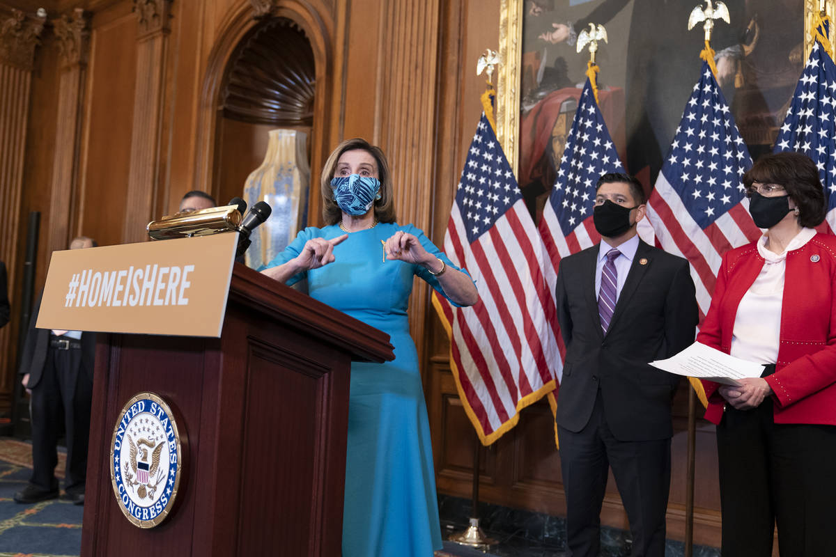 Speaker of the House Nancy Pelosi, D-Calif., joined at right by Rep. Raul Ruiz, D-Calif., chair ...
