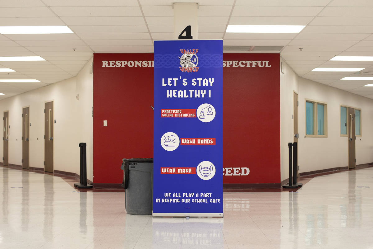 Signs ask students and staff to follow COVID-19 protocol at Valley High School on Friday, March ...