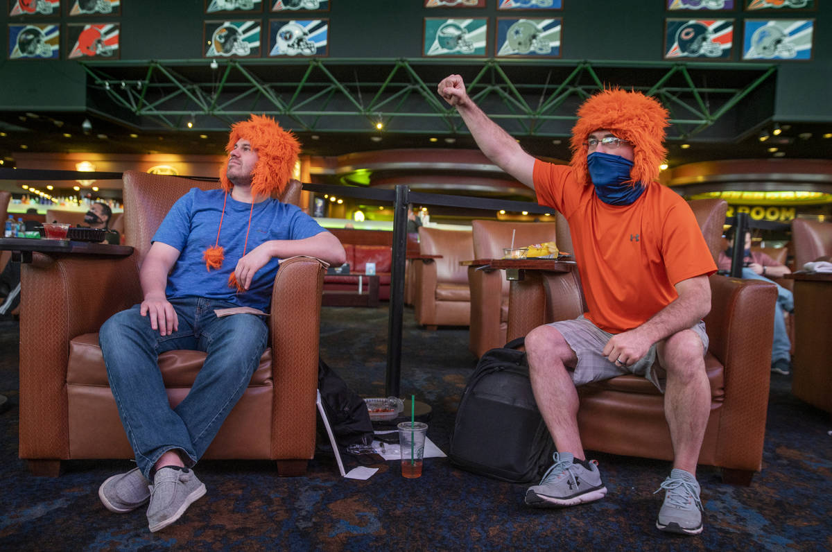 Dillan Sirbaugh, left, Jason Rowcliff of Decatur, Ill., enjoy the action during opening day of ...
