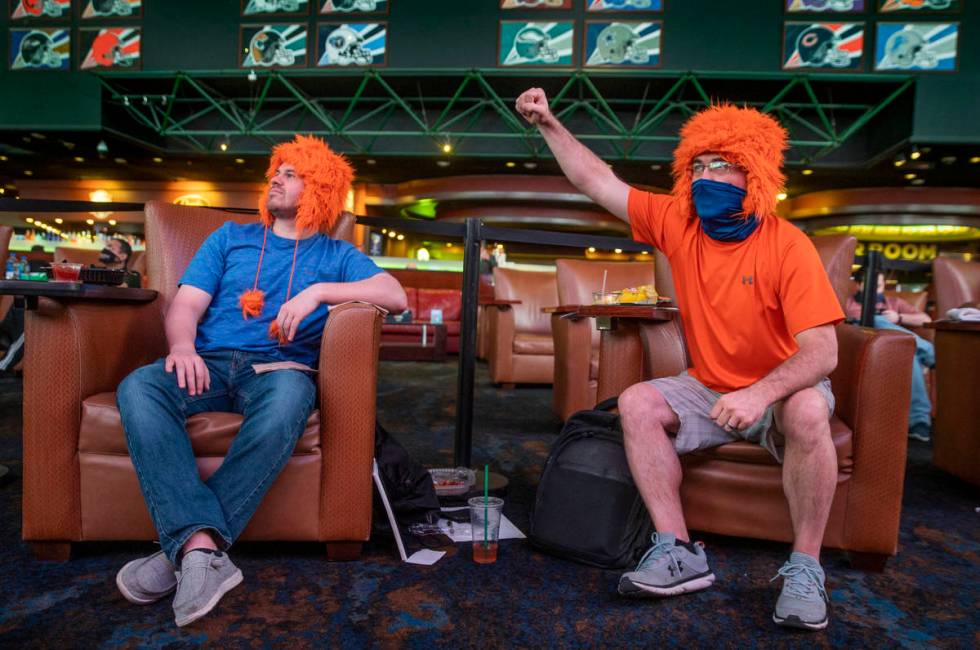 Dillan Sirbaugh, left, Jason Rowcliff of Decatur, Ill., enjoy the action during opening day of ...