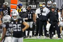 Raiders head coach Jon Gruden shouts from the sidelines with his mask down in the fourth quarte ...