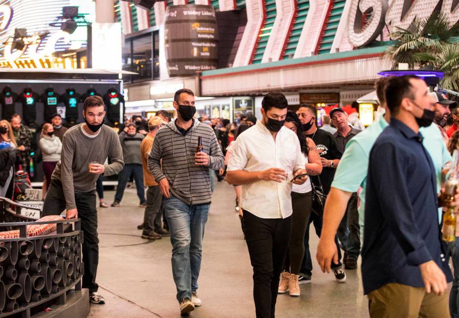 People visit the Fremont Street Experience in Las Vegas, Friday, March 19, 2021. (Erik Verduzco ...