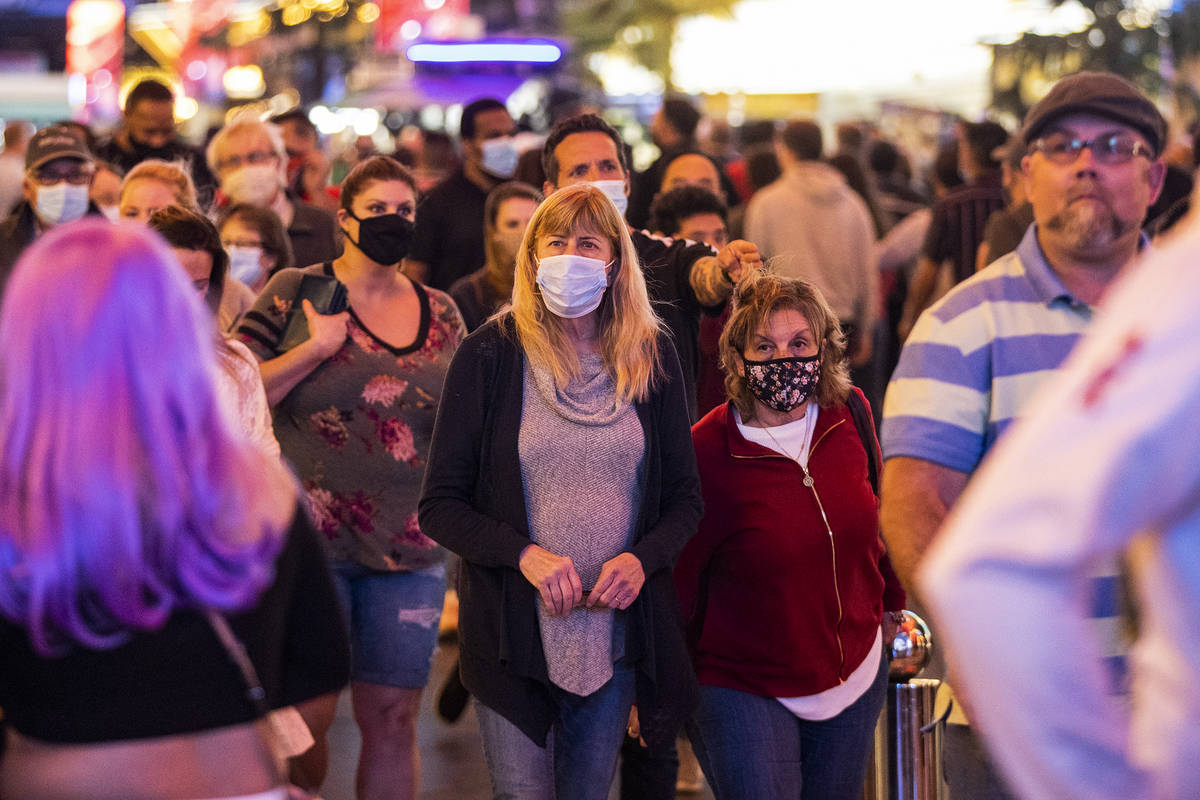 People visit the Fremont Street Experience in Las Vegas, Friday, March 19, 2021. (Erik Verduzco ...