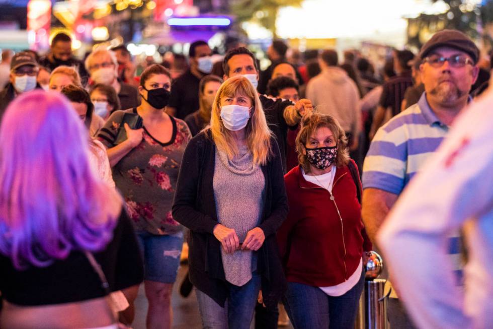 People visit the Fremont Street Experience in Las Vegas, Friday, March 19, 2021. (Erik Verduzco ...