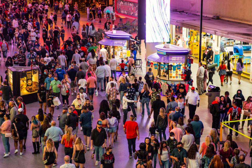 People visit the Fremont Street Experience in Las Vegas, Friday, March 19, 2021. (Erik Verduzco ...