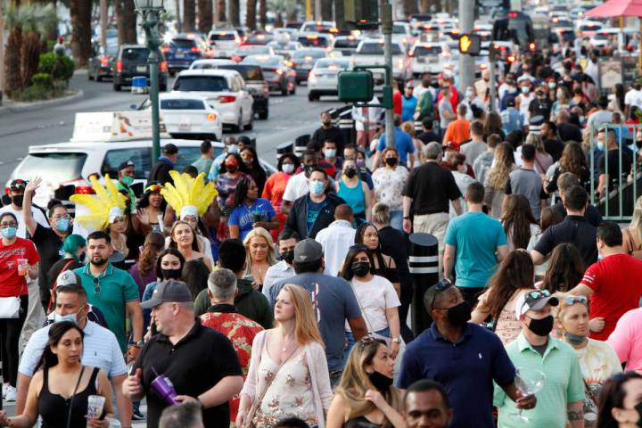 People walk along the Las Vegas Strip Friday, March 19, 2021, in Las Vegas. (Chitose Suzuki / L ...