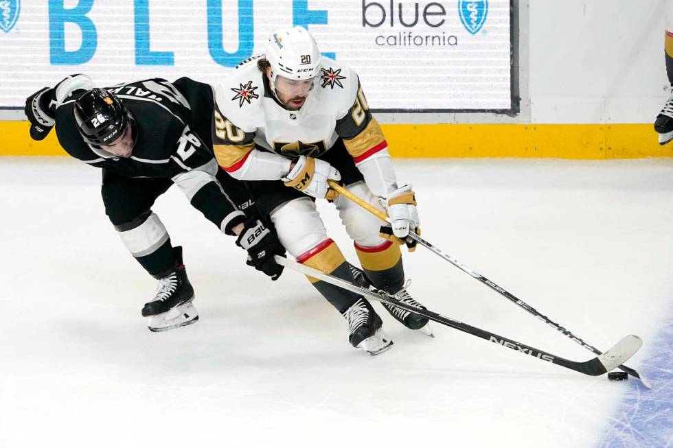 Los Angeles Kings defenseman Sean Walker, left, and Vegas Golden Knights center Chandler Stephe ...