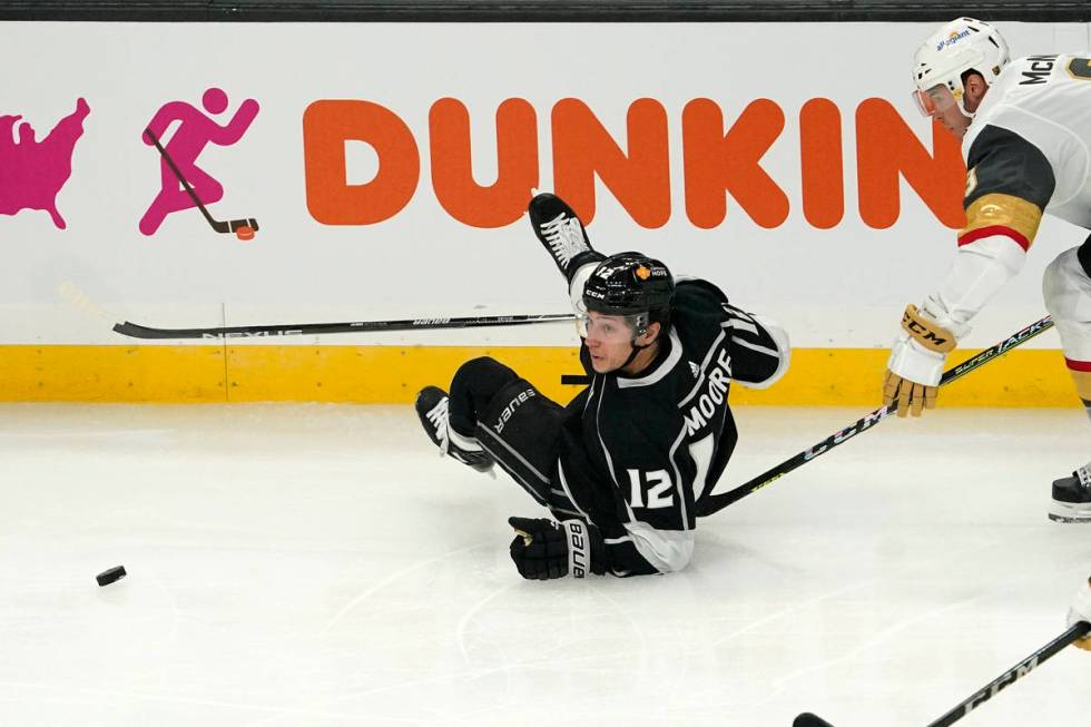 Los Angeles Kings center Trevor Moore, left, goes down while under pressure from Vegas Golden K ...