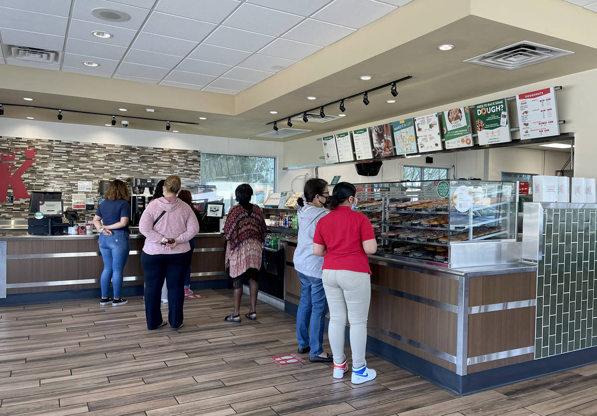 Customers buy donuts at Kirspy Kreme on Craig Road in North Las Vegas Monday, March 22, 2021. K ...