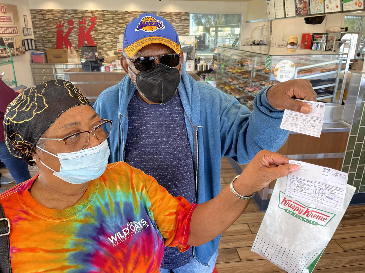 Debi and Willis Powell show their free doughnuts at Kirspy Kreme on Craig Road in North Las Veg ...