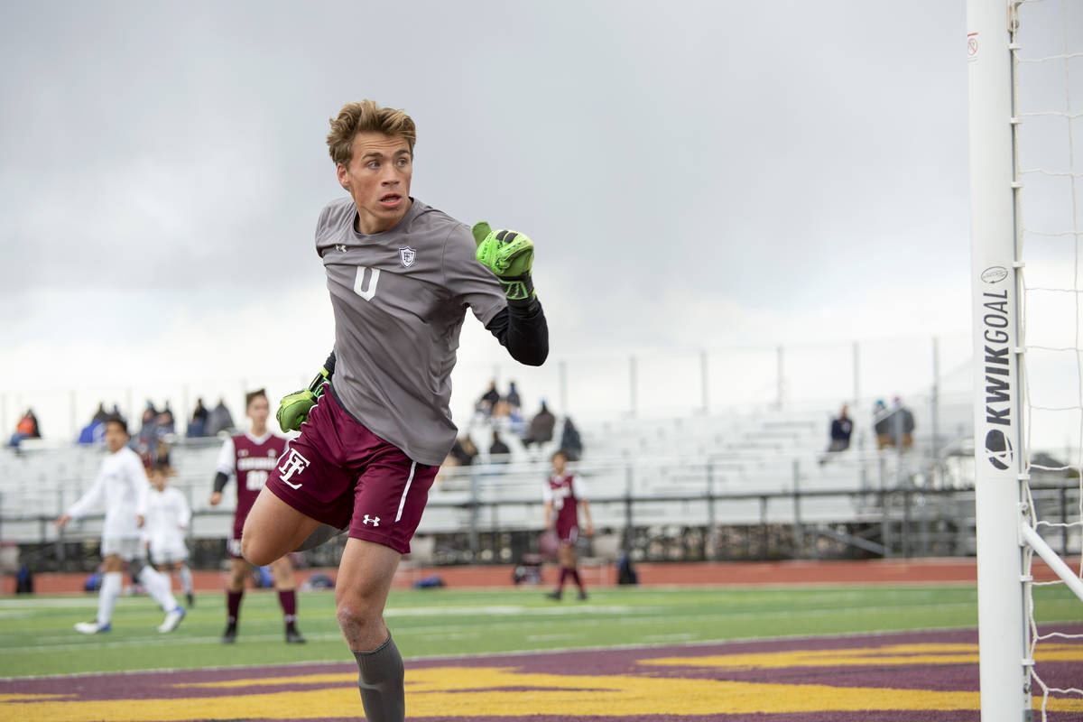 Faith Lutheran goalkeeper Landon Amick (0) looks to see that his block of a Bishop Gorman point ...