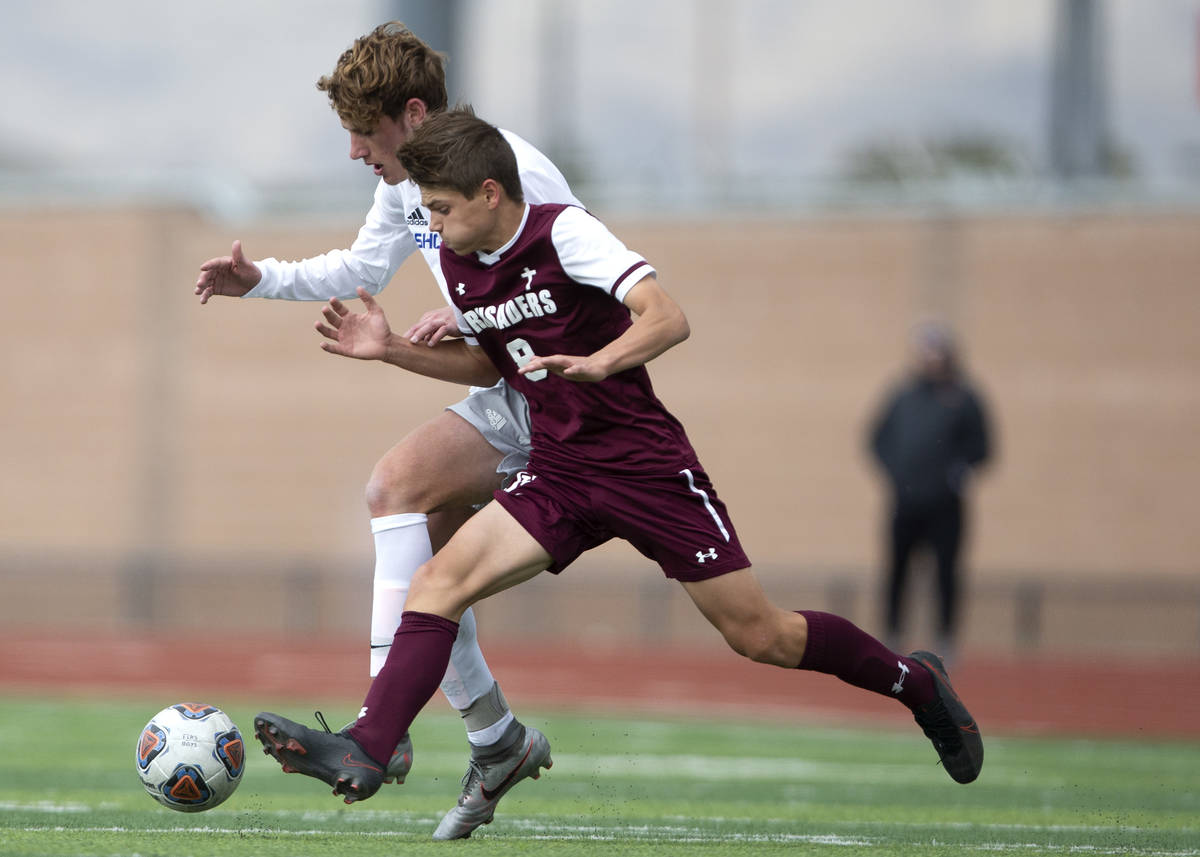 Bishop Gorman midfielder Nathaniel Roberts (5) runs for the ball alongside Faith Lutheran midfi ...