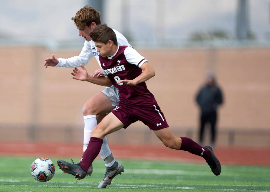 Bishop Gorman midfielder Nathaniel Roberts (5) runs for the ball alongside Faith Lutheran midfi ...