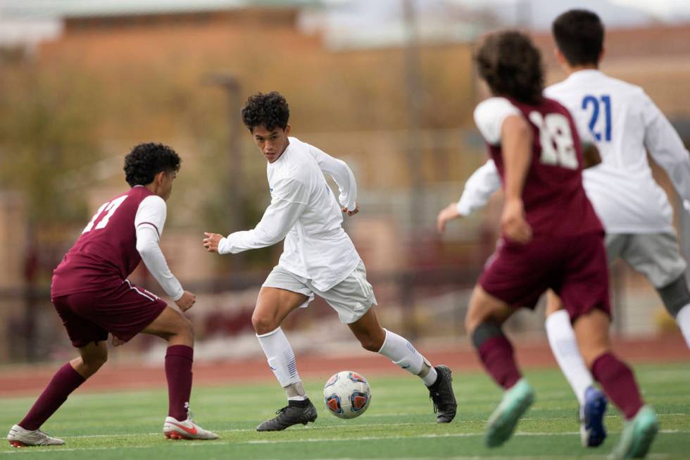 Faith Lutheran midfielder Preston Rincon, left, and Bishop Gorman defender Goerge Charles (15), ...