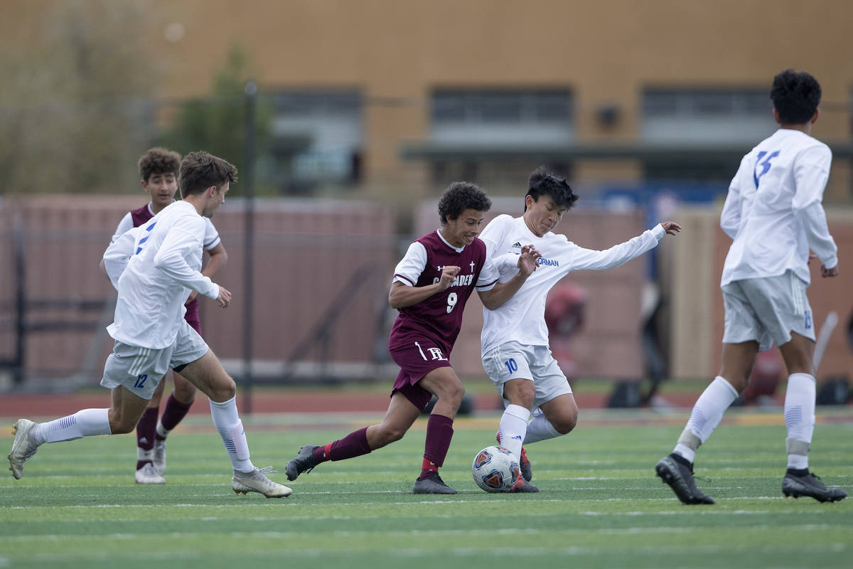 Faith Lutheran forward Josh Gilmer (9) and Bishop Gorman midfielder Aidan Yamachika (10) compet ...