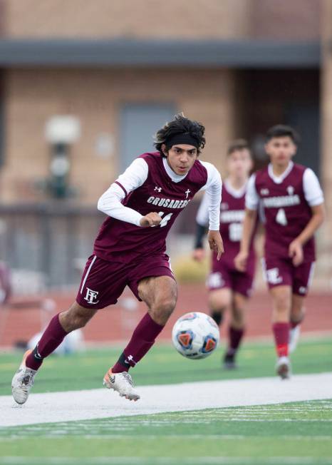 Faith Lutheran forward Ari Sirvent (14) eyes the ball during a high school soccer game against ...