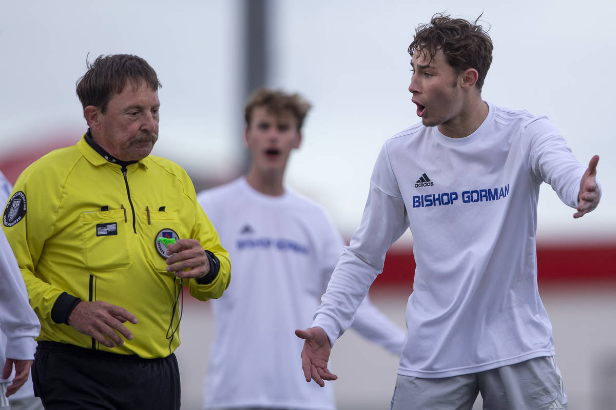 Bishop Gorman defender Keegan Brooks (4), right, argues with a referee about a call made during ...