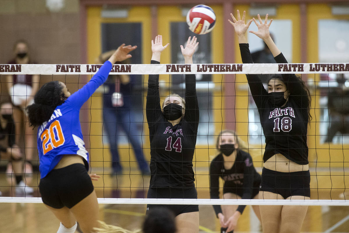 Bishop Gorman's Sophia Ewalefo (20) spikes while Faith Lutheran's Ella Runstad (14) and Haylee ...