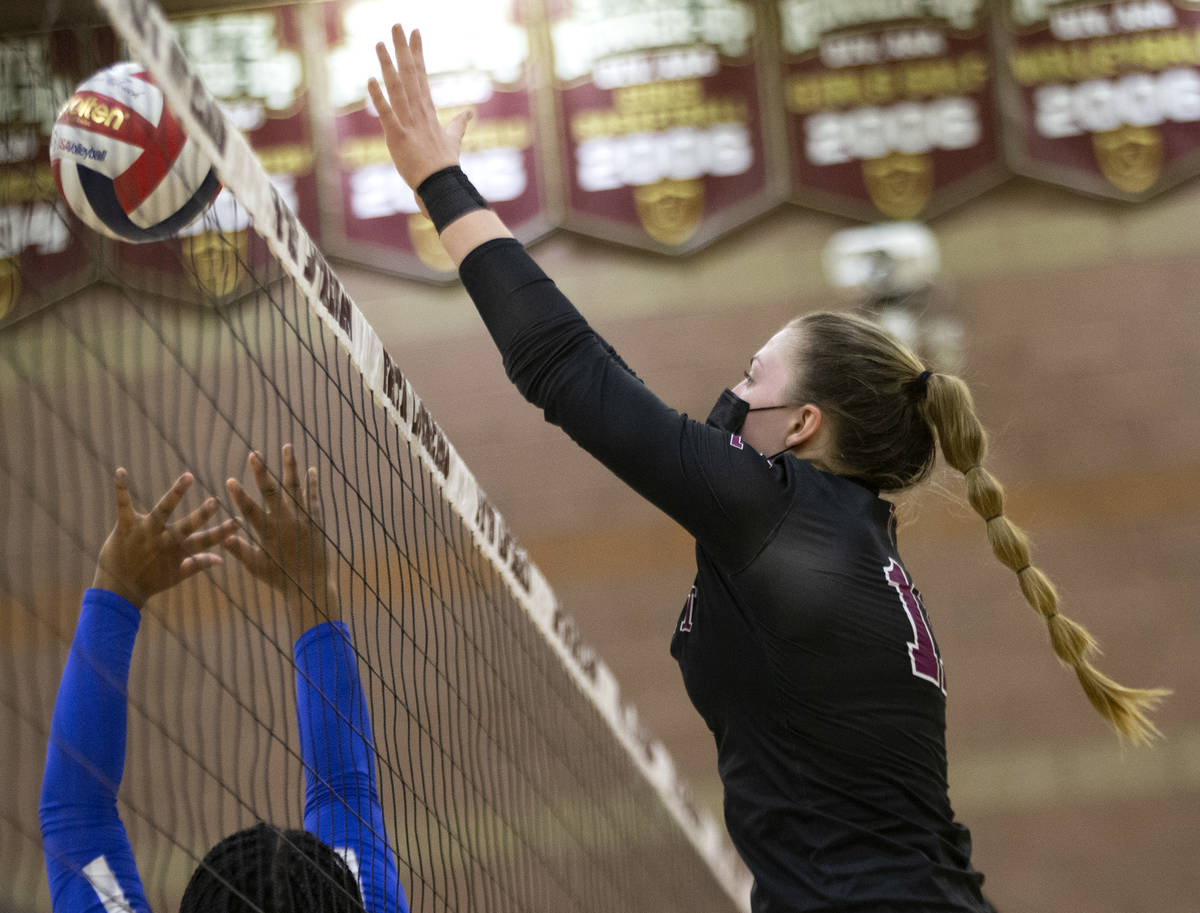 Faith Lutheran's Claudia Grepke (11) reaches to block as Bishop Gorman's Taylor Treadwell (24) ...