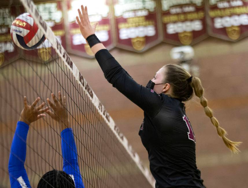 Faith Lutheran's Claudia Grepke (11) reaches to block as Bishop Gorman's Taylor Treadwell (24) ...