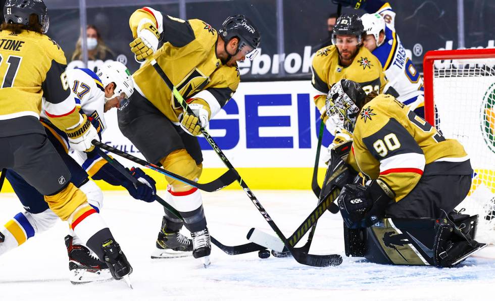 St. Louis Blues' Jaden Schwartz (17) battles for the puck against Golden Knights' Brayden McNab ...