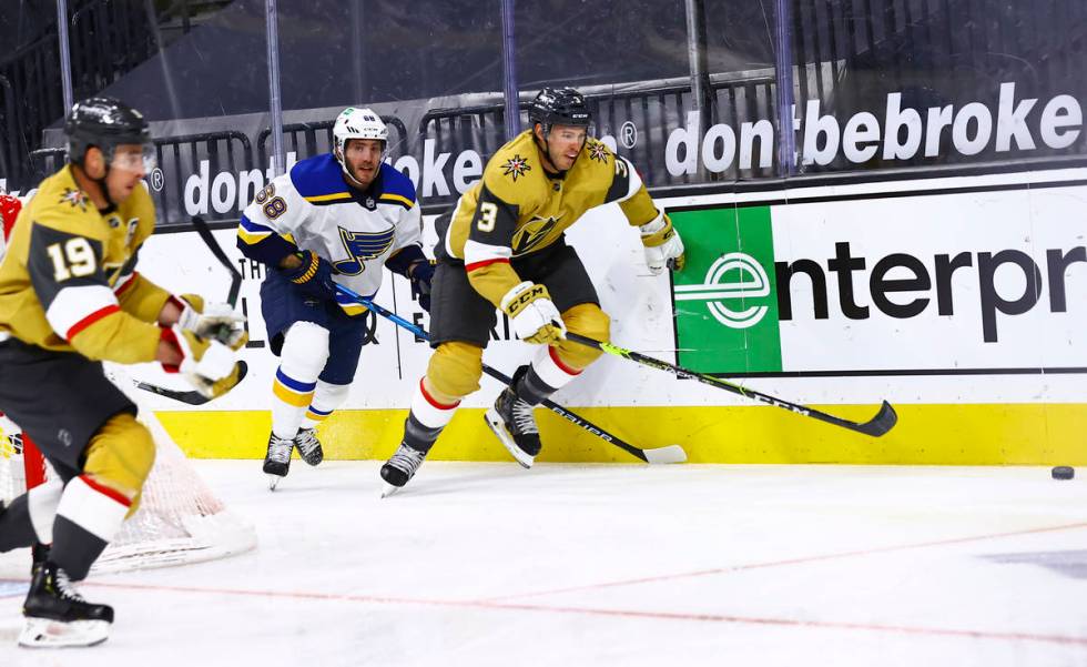 Golden Knights' Brayden McNabb (3) goes after the puck in front of St. Louis Blues' Mike Hoffma ...