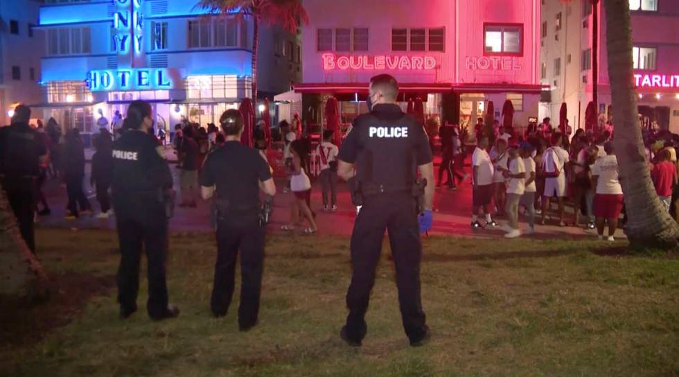In this image taken from video, police officers stand guard March 20 as crowds descend on South ...