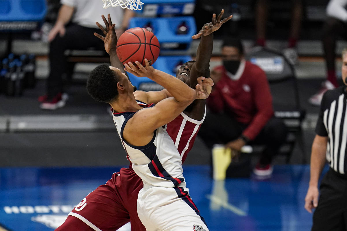 Gonzaga guard Jalen Suggs (1) charges into Oklahoma forward Kur Kuath (52) in the first half of ...