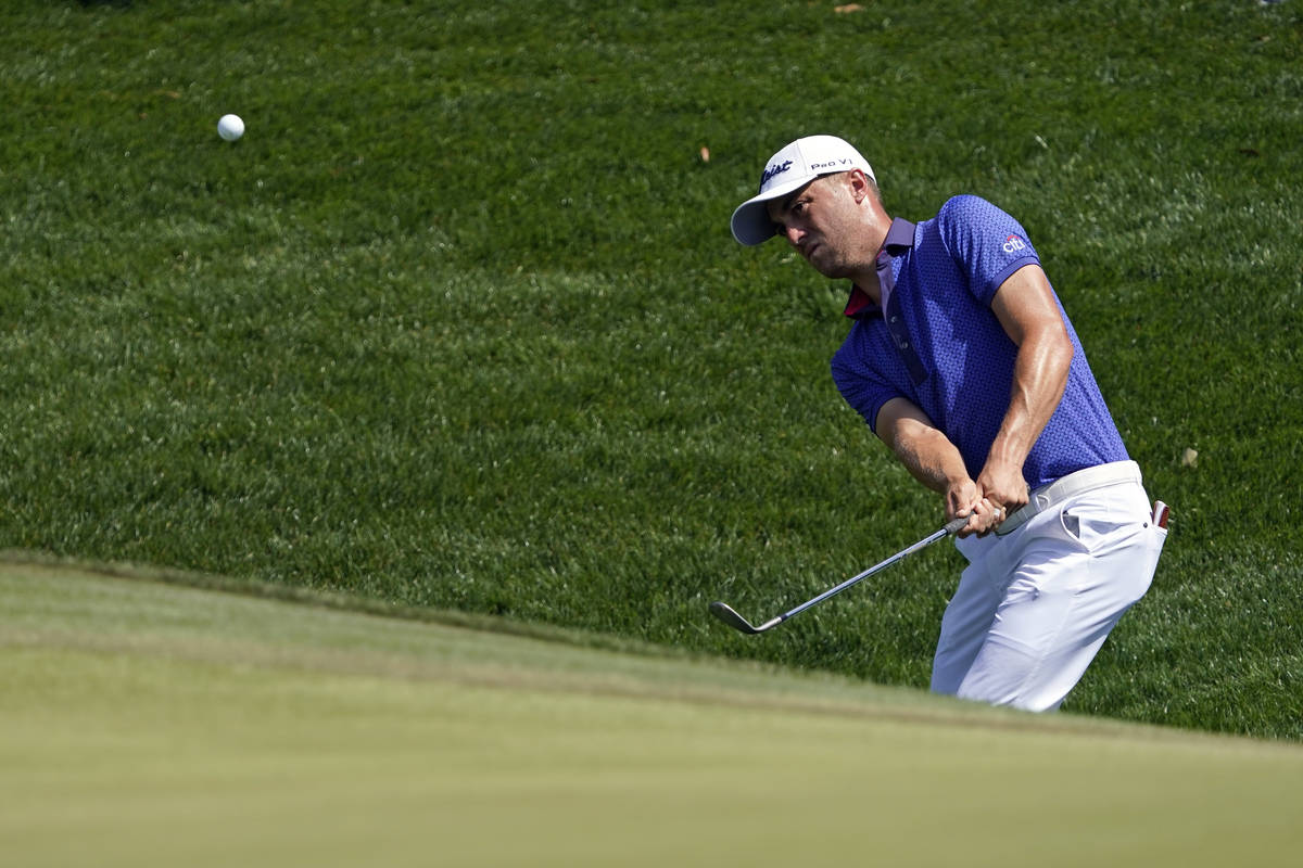 Justin Thomas chips during the final round at The Players Championship golf tournament Sunday, ...